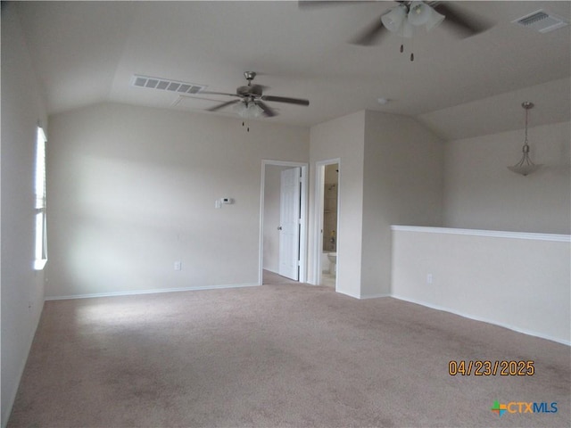 unfurnished room featuring ceiling fan, visible vents, carpet, baseboards, and lofted ceiling
