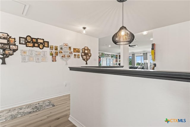5998 Galveston Rd, Belton, TX 76513 - detailed view of wood finished floors, baseboards, and refrigerator