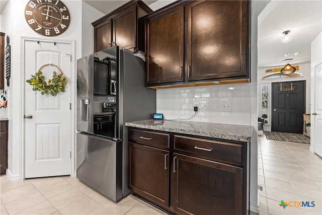 5998 Galveston Rd, Belton, TX 76513 - kitchen with black fridge with ice dispenser, light tile patterned floors, and decorative backsplash