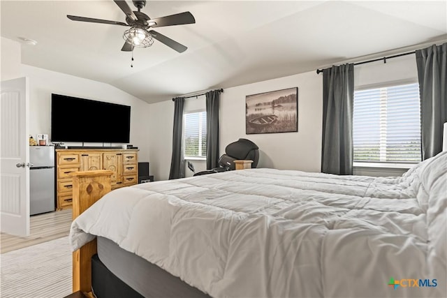 5998 Galveston Rd, Belton, TX 76513 - bedroom featuring freestanding refrigerator, lofted ceiling, light wood-style flooring, and a ceiling fan
