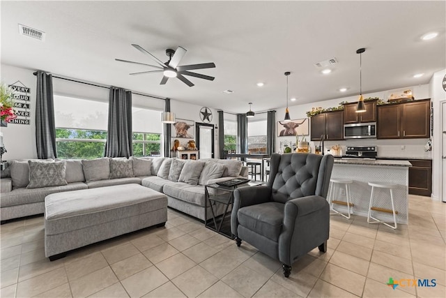 5998 Galveston Rd, Belton, TX 76513 - living area featuring light tile patterned floors, ceiling fan, and recessed lighting