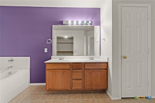 1505 Line Dance Ct, Killeen, TX 76542 - bathroom featuring double vanity, a bath, a closet, tile patterned flooring, and baseboards