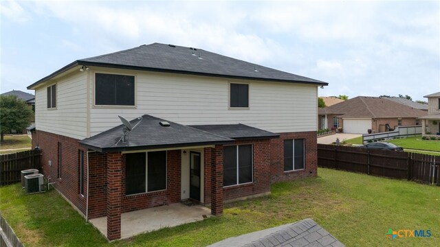 1505 Line Dance Ct, Killeen, TX 76542 - back of property featuring brick siding, a patio, a shingled roof, and central AC unit