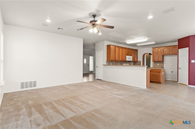 1505 Line Dance Ct, Killeen, TX 76542 - unfurnished living room with light colored carpet, a ceiling fan, recessed lighting, light tile patterned floors, and baseboards