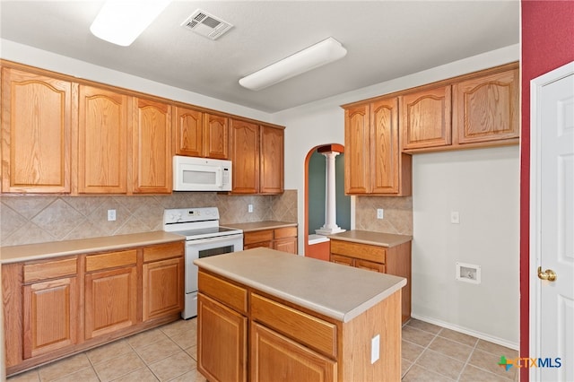 1505 Line Dance Ct, Killeen, TX 76542 - kitchen with white appliances, light tile patterned floors, decorative backsplash, light countertops, and a center island