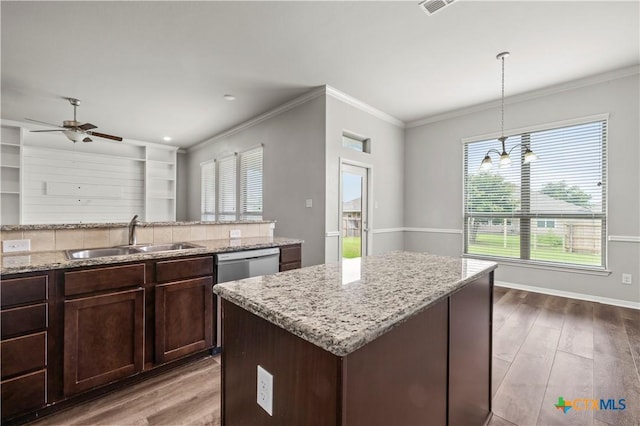 8113 Iron Gate Dr, Temple, TX 76502 - kitchen with wood finished floors, light stone countertops, crown molding, ceiling fan, and pendant lighting