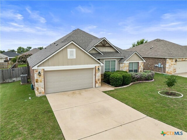 8113 Iron Gate Dr, Temple, TX 76502 - view of front of home with a shingled roof, a garage, concrete driveway, and board and batten siding