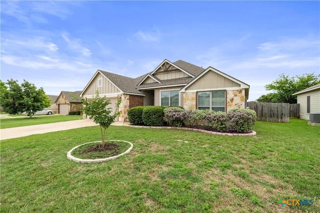 8113 Iron Gate Dr, Temple, TX 76502 - view of front of home featuring board and batten siding, concrete driveway, an attached garage, and stone siding