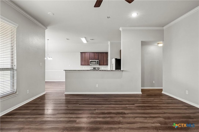 8113 Iron Gate Dr, Temple, TX 76502 - unfurnished living room featuring a ceiling fan, ornamental molding, and dark wood finished floors