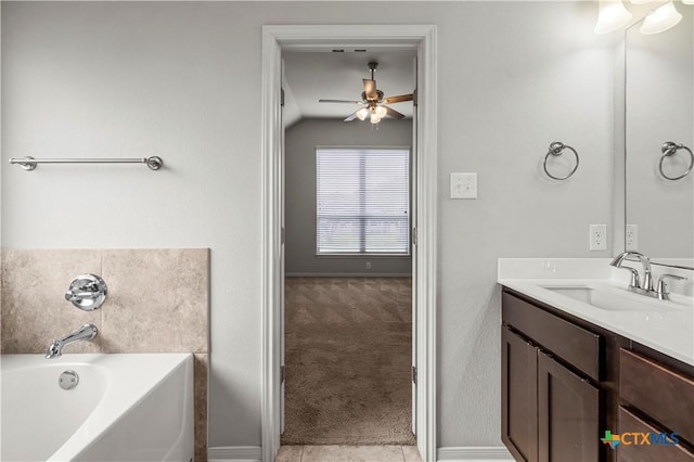 8113 Iron Gate Dr, Temple, TX 76502 - bathroom featuring a ceiling fan, vanity, a garden tub, vaulted ceiling, and tile patterned floors