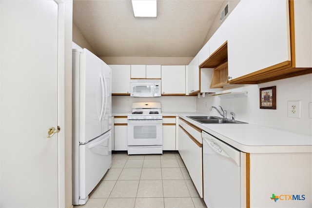 kitchen with white appliances, white cabinetry, sink, and a textured ceiling