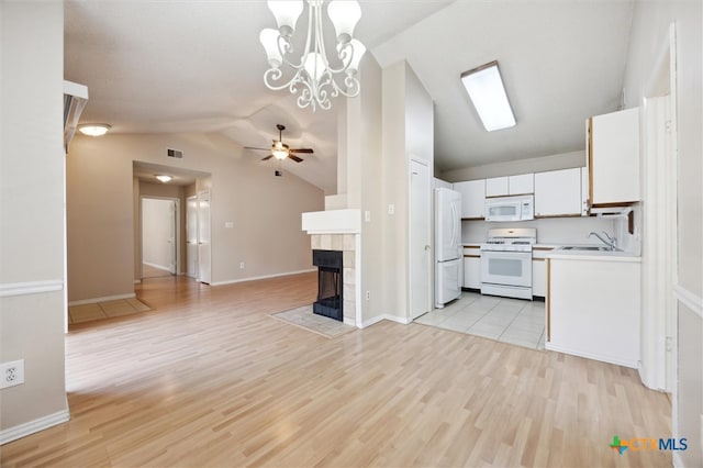 kitchen with light hardwood / wood-style floors, decorative light fixtures, white appliances, lofted ceiling, and white cabinets