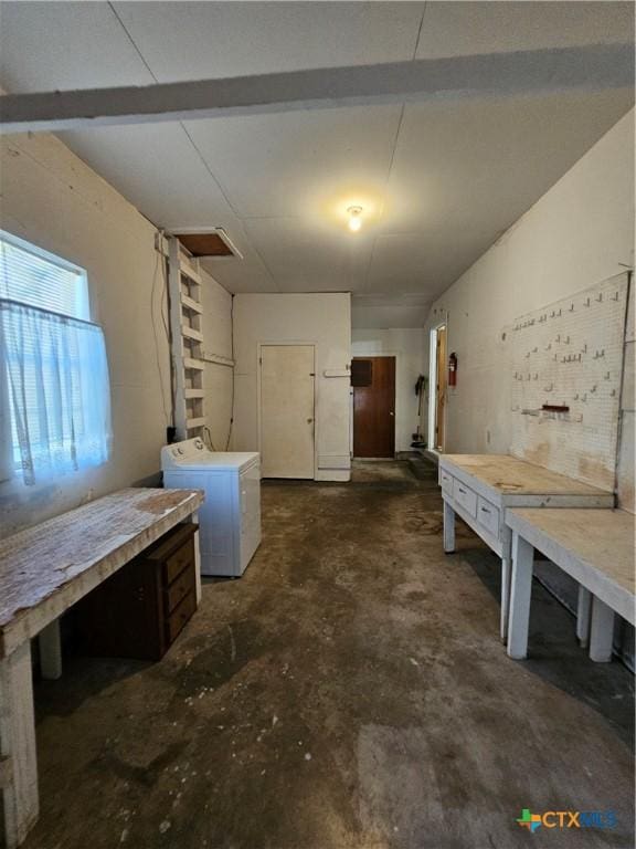 basement featuring a workshop area and washing machine and clothes dryer