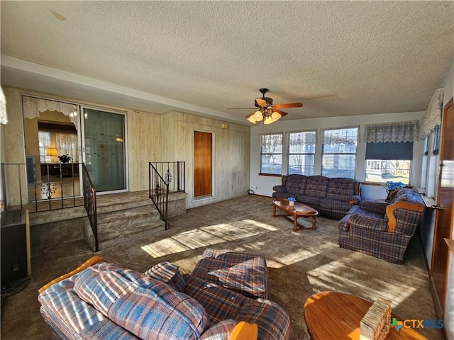 carpeted living area with plenty of natural light, a textured ceiling, and ceiling fan