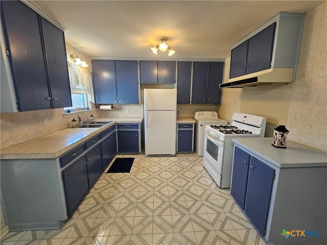 kitchen featuring white appliances, blue cabinets, light countertops, and a sink