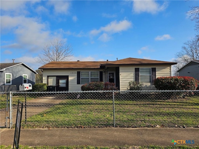 view of front facade with a fenced front yard and a front lawn