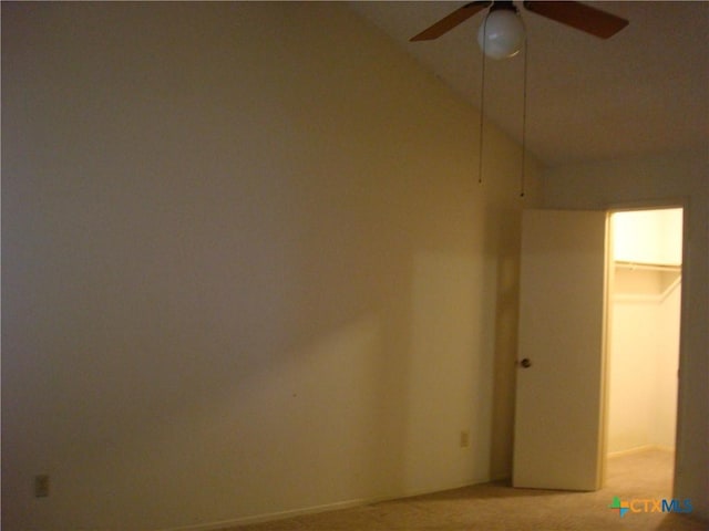 unfurnished room featuring vaulted ceiling, light carpet, and ceiling fan