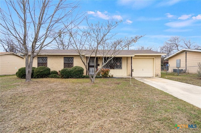 ranch-style home featuring a garage and a front lawn