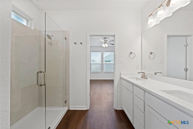 606 Killam Dr, Temple, TX 76502 - full bath with wood finished floors, a shower stall, a ceiling fan, double vanity, and baseboards