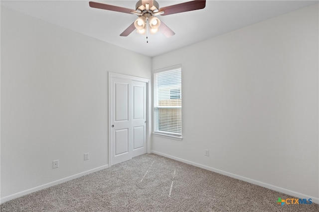 carpeted empty room with ceiling fan