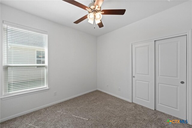 606 Killam Dr, Temple, TX 76502 - unfurnished bedroom with carpet floors, multiple windows, and baseboards