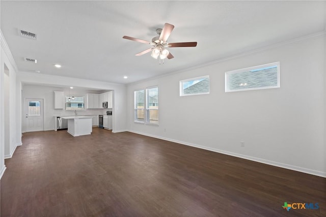 606 Killam Dr, Temple, TX 76502 - unfurnished living room featuring ornamental molding, baseboards, a ceiling fan, dark wood-style floors, and recessed lighting