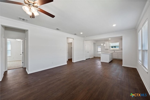 606 Killam Dr, Temple, TX 76502 - unfurnished living room with a ceiling fan, dark wood-type flooring, baseboards, ornamental molding, and recessed lighting