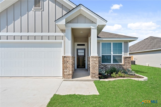 entrance to property with a garage and a yard