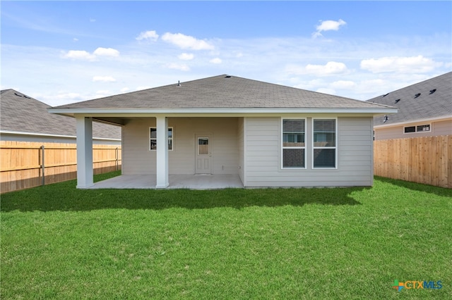 rear view of house featuring a patio area and a lawn