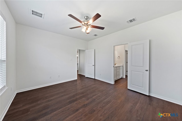 unfurnished bedroom featuring connected bathroom, ceiling fan, and dark hardwood / wood-style floors