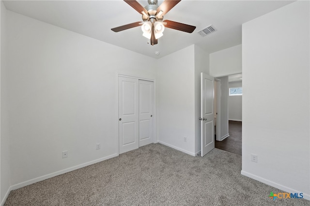 unfurnished bedroom with a closet, light carpet, and ceiling fan