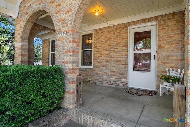 215 Taylor Rd, Elgin, TX 78621 - view of exterior entry with brick siding and a porch