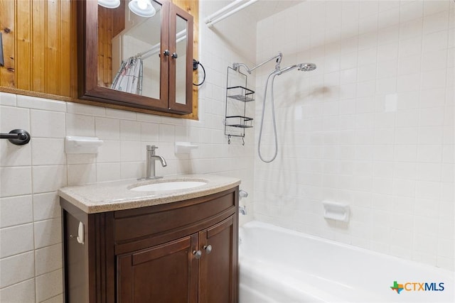 215 Taylor Rd, Elgin, TX 78621 - full bathroom with vanity, decorative backsplash, shower / bath combo, and tile walls