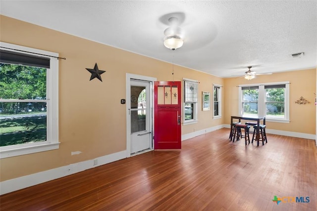 215 Taylor Rd, Elgin, TX 78621 - dining space with visible vents, wood finished floors, baseboards, ceiling fan, and a textured ceiling