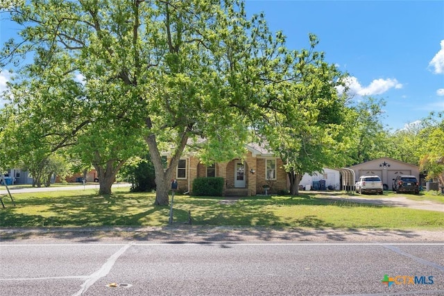 215 Taylor Rd, Elgin, TX 78621 - obstructed view of property featuring a front lawn and brick siding