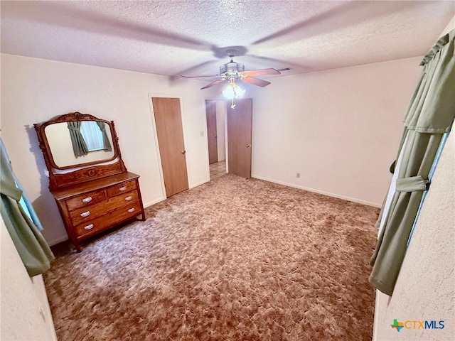 unfurnished bedroom featuring carpet flooring, ceiling fan, and a textured ceiling