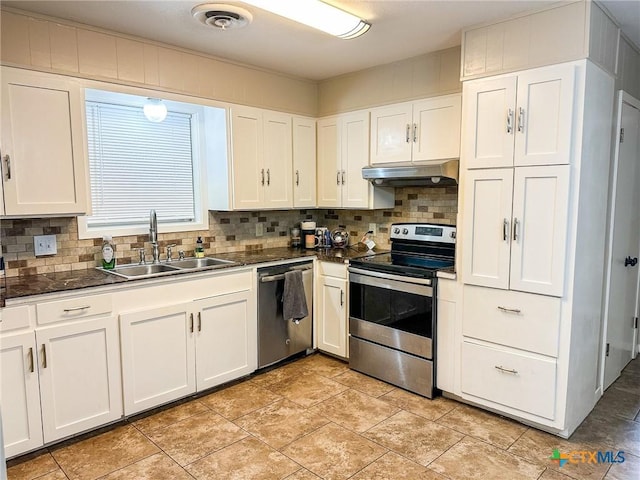 111 Kenilworth Glen St, Victoria, TX 77904 - kitchen featuring stainless steel appliances, under cabinet range hood, a sink, dark countertops, and tasteful backsplash