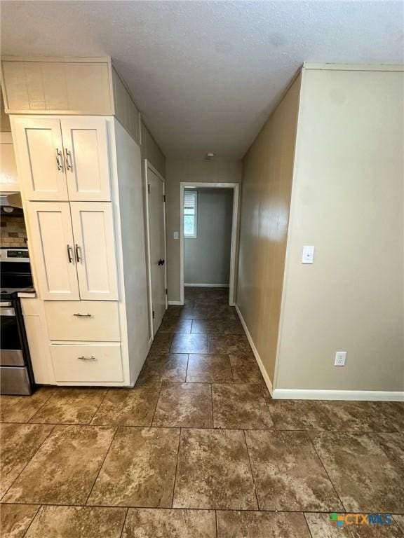111 Kenilworth Glen St, Victoria, TX 77904 - hall with baseboards and dark stone finish floors
