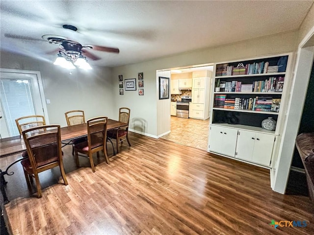 111 Kenilworth Glen St, Victoria, TX 77904 - dining room with ceiling fan, light wood-style flooring, a textured ceiling, and baseboards