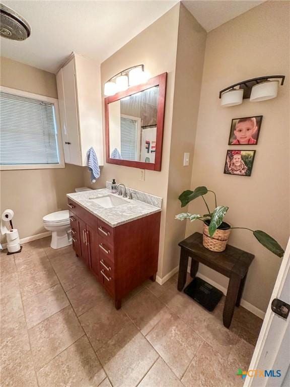 111 Kenilworth Glen St, Victoria, TX 77904 - full bath with vanity, toilet, baseboards, and tile patterned flooring