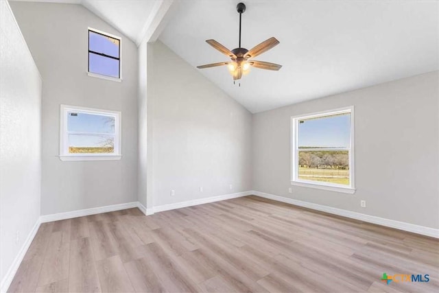 spare room featuring light wood-style floors, baseboards, and ceiling fan