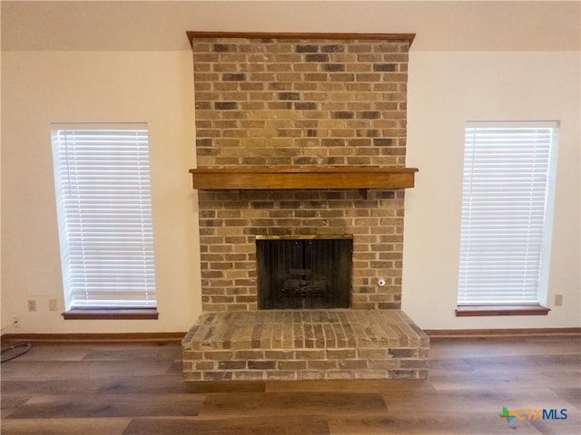 101 Maplewood Dr Unit 28, Victoria, TX 77901 - detailed view of wood finished floors, a fireplace, and baseboards