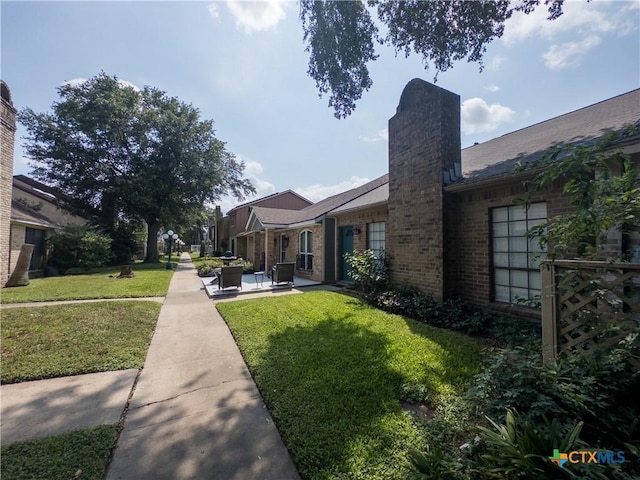 101 Maplewood Dr Unit 28, Victoria, TX 77901 - view of green lawn with a patio