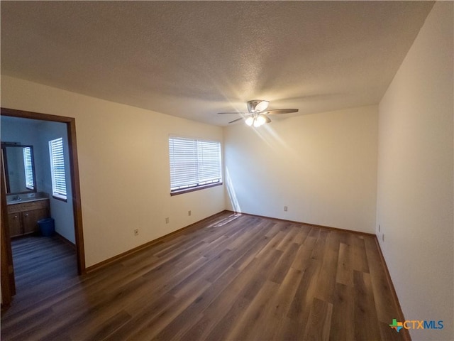 101 Maplewood Dr Unit 28, Victoria, TX 77901 - spare room featuring a ceiling fan, dark wood-style flooring, baseboards, and a textured ceiling