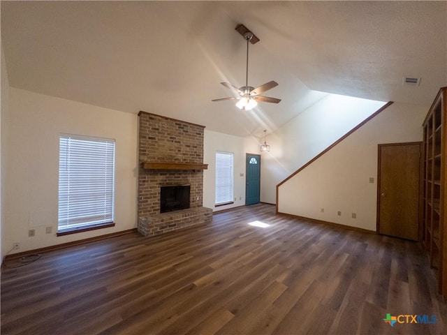101 Maplewood Dr Unit 28, Victoria, TX 77901 - unfurnished living room with ceiling fan, vaulted ceiling, wood finished floors, a fireplace, and baseboards
