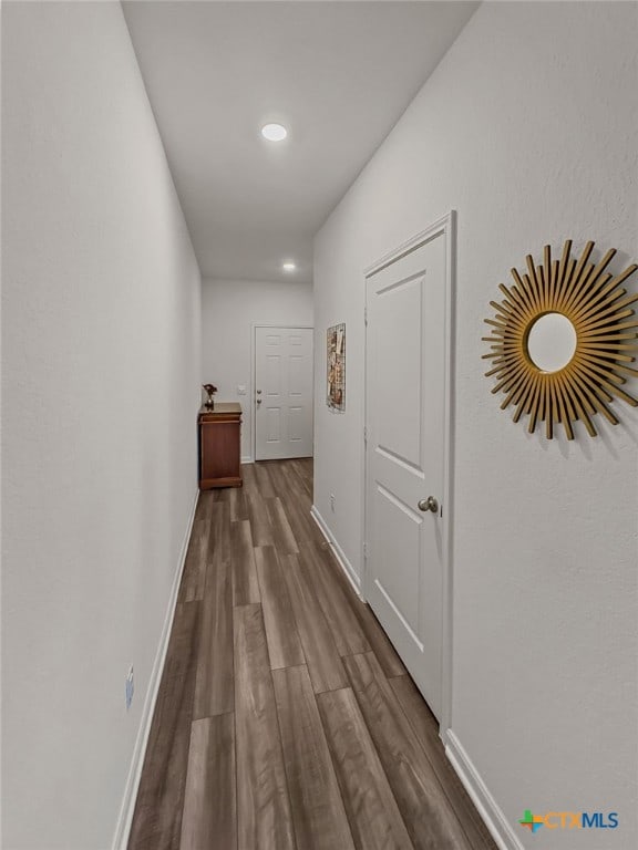 hallway with hardwood / wood-style floors