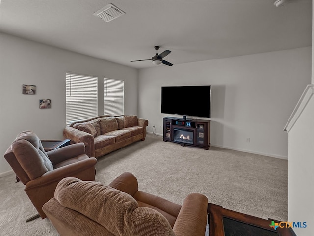 living room featuring light carpet and ceiling fan