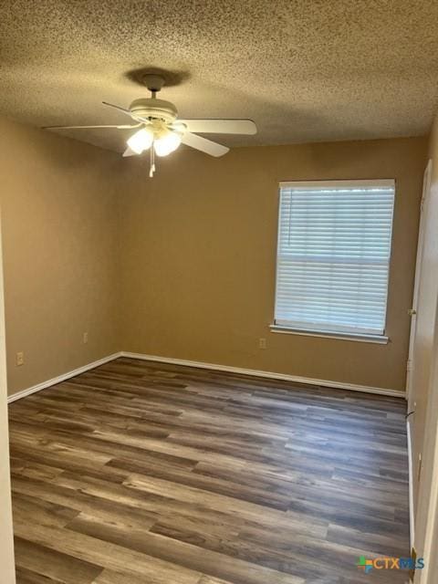 unfurnished room featuring ceiling fan, dark hardwood / wood-style flooring, and a textured ceiling