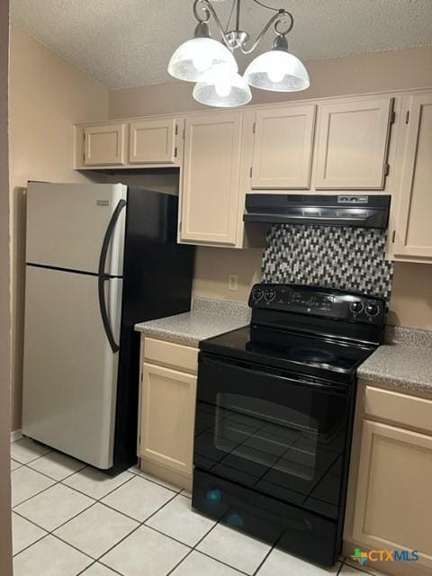 kitchen featuring stainless steel refrigerator, black electric range oven, a chandelier, pendant lighting, and light tile patterned flooring