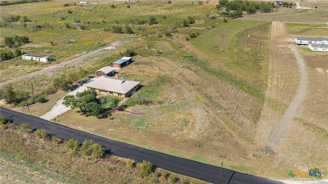 birds eye view of property with a rural view